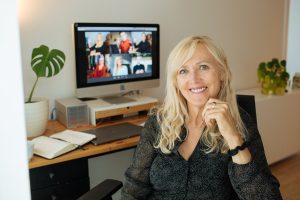 Smiling mature woman having video call via computer in the home